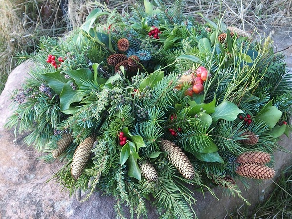 Ein Adventskranz liegt auf einem großen Buntsandsteinblock